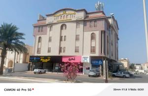 a building on the corner of a street at رندة المدن للشقق المخدومة in Jazan