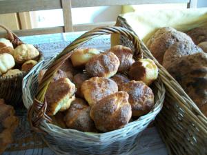 a basket of bread and pastries on a table at Bed and Cèpes in Busserolles +13 photos