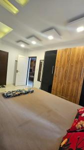 a bedroom with a bed and wooden cabinets at Dev And Ganga Homes in Trichūr