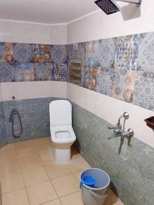 a bathroom with a toilet and a sink at Dreamy beach in Puducherry