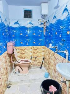 a bathroom with a toilet and a sink at Jagannath guest house in Udaipur