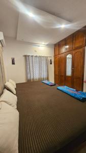 a bedroom with two beds and wooden cabinets at Dev And Ganga Homes in Trichūr