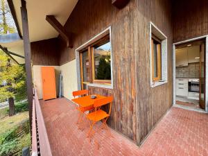a house with a table and chairs on a patio at Ampio appartamento per 8 a due passi dal centro in Bardonecchia