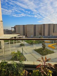 a view of a building with a bridge in front of it at Aeon Towers 2BR in Sheikh Zayed