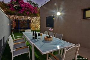 a table with bottles of wine sitting on a patio at סוויטת אפנדי in Ya‘ara