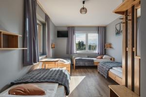 Кровать или кровати в номере Pensjonat Ognisty Wdżar - Velo czorsztyn - CzorsztynSki - Pieniny -Jezioro Czorsztyńskie -