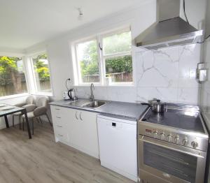a kitchen with a sink and a stove at 3 Bedroom and big yard in Hamilton