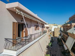 a balcony of a building with chairs on it at Harbour, the Unique Chania Old Town Apt in Chania Town