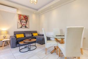 a living room with a couch and a table at Harbour, the Unique Chania Old Town Apt in Chania Town