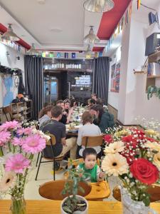 a group of people sitting at tables in a restaurant at Dalat Tiny Tigers Hostel in Da Lat +21 photos