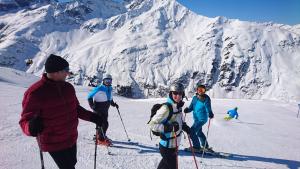 a group of people on skis on a snow covered mountain at Haus Rose in Schröcken