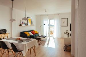 a living room with a table and a couch at HORIA -Sundrenched apartment with terrace in Cabo de Gata in El Pozo de los Frailes