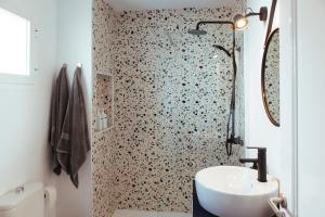 a bathroom with a white sink and a shower at HORIA -Sundrenched apartment with terrace in Cabo de Gata in El Pozo de los Frailes +21 photos