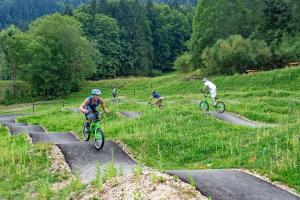 a group of people riding bikes down a hill at Hôtel Le Bec Bed and Chocolate self check-in in Fleurier