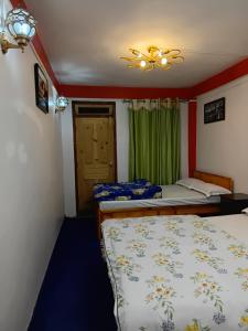 a bedroom with two beds and a ceiling fan at Bloomfield Farmhouse 2 in Darjeeling +8 photos