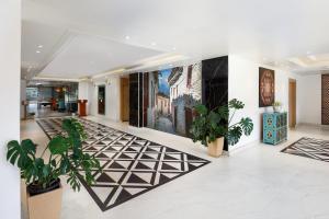 un vestíbulo con plantas y pinturas en las paredes en Hotel Anuttara, Boudha, en Baudhatinchule