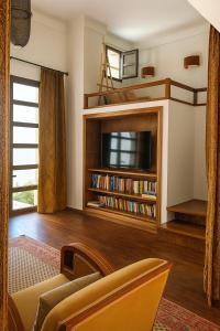 a living room with a flat screen tv and a couch at Riad Maison de ville piscine privée in El Jadida +44 photos