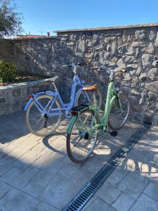 Dos bicicletas están aparcadas junto a un muro de piedra. en Donatella Apartment 2, en Podstrana