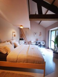 a bedroom with a large bed and a table at Mera Wellness B&B in America +100 photos