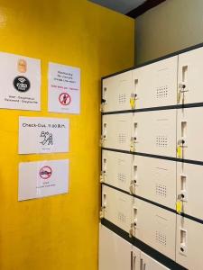 two lockers in a room with signs on the wall at Easy Hostel in Phi Phi Don +41 photos