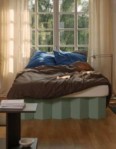 a bed sitting in a room with a window at Your exclusive holiday home in Winterthur