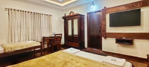 Ένα ή περισσότερα κρεβάτια σε δωμάτιο στο Hotel Manorama