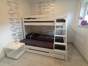 a room with bunk beds with a wall with writing at Ferienhaus Marina in Floh