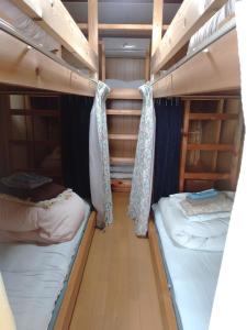a small room with two bunk beds in it at 二段ベッドの宿青と白 in Aki
