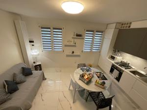 a small living room with a couch and a table at B&B Kira Home in La Mura +21 photos