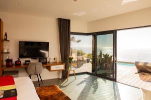 a living room with a view of the ocean at Sea Star Rocks Boutique Hotel in Cape Town