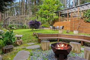 a fire pit in a garden with a bench and a fire grill at Tranquill 4BR Retreat in Sassafras