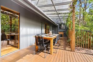a patio with a table and chairs on a deck at Tranquill 4BR Retreat in Sassafras +23 photos