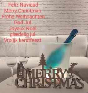 a table with a glass bowl with a pen and a christmas sign at Casa Fuerte Playa in La Herradura