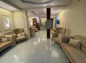 a lobby with couches and chairs in a building at Pyramids star of Khafre in Cairo