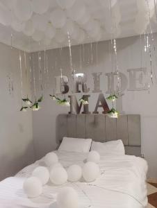 a bedroom with a white bed with a sign that reads bedmate at Pyramids star of Khafre in Cairo +94 photos