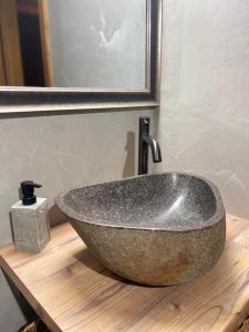 a bathroom sink on a wooden counter with a mirror at Gstaad Chalet in Gstaad