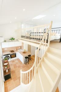 a kitchen and a living room with a staircase at Le Nily Provence, douceur & vue d'exception in Sainte-Tulle