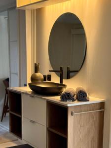 a bathroom with a sink and a mirror on a counter at Ljungskile modern country lodge in Grötån +18 photos