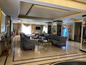 a large living room with couches and a table at Lake view Palace Hotel in Baku