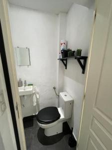a small bathroom with a toilet and a sink at Cozy house with garden in Mulhouse +25 photos