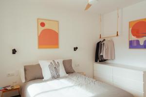 a bedroom with a bed and some pictures on the wall at ZURIA - Casa tranquila con patio en Cabo de Gata in El Pozo de los Frailes