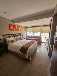 a bedroom with a large bed and a television at Caseros3 in Salta +63 photos