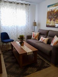a living room with a couch and a coffee table at La Esperanza Apartaments in La Esperanza +40 photos