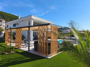 a wooden house with a pool in front of it at Villa Milamar in Banjol