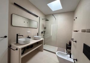 a bathroom with two sinks and a shower at casamujeres in Punta de Mujeres +54 photos