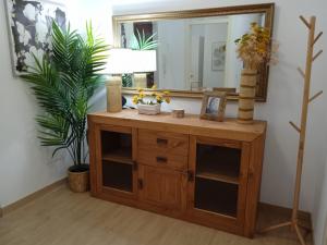 a bathroom with a wooden dresser with a mirror at La Esperanza Apartaments in La Esperanza