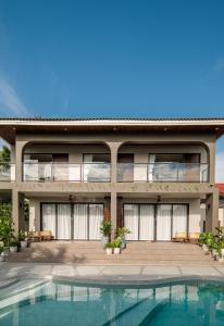 an exterior view of a villa with a swimming pool at naravi gardenandpool kohlarn in Ko Sak +9 photos