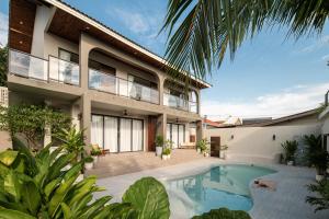 an exterior view of a house with a swimming pool at naravi gardenandpool kohlarn in Ko Sak