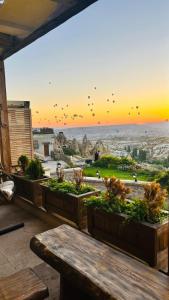 a patio with a table and a view of the city at Ages in Cappadocia Premium in Uchisar
