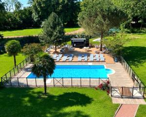 an overhead view of a swimming pool in a yard at Logis Hôtels Château de La Barge in Chaintré +22 photos